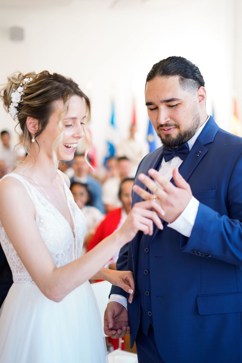 A couple sharing a joyful moment during their wedding ceremony as they exchange rings.