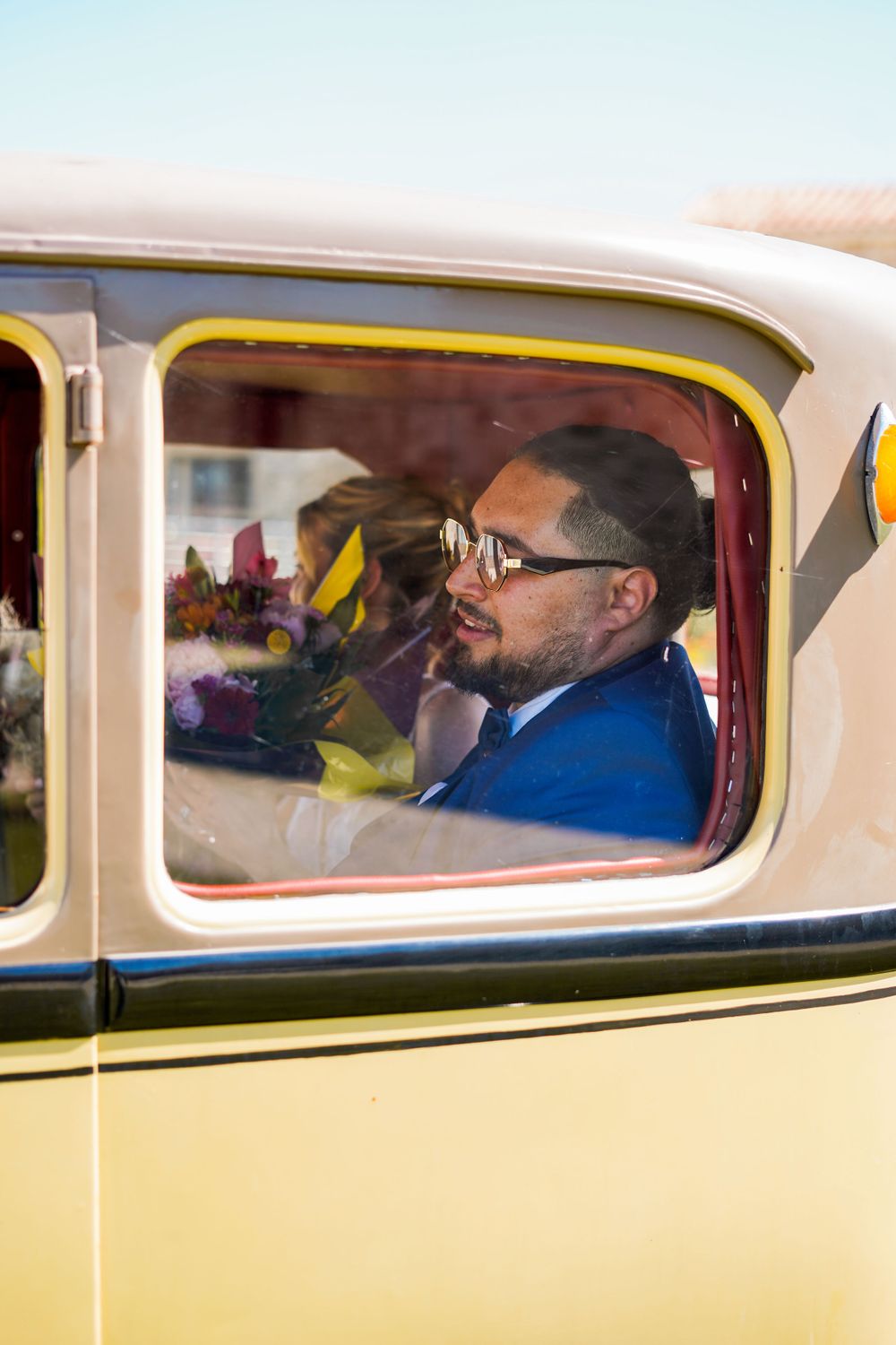 View through vintage car window showing interior details.