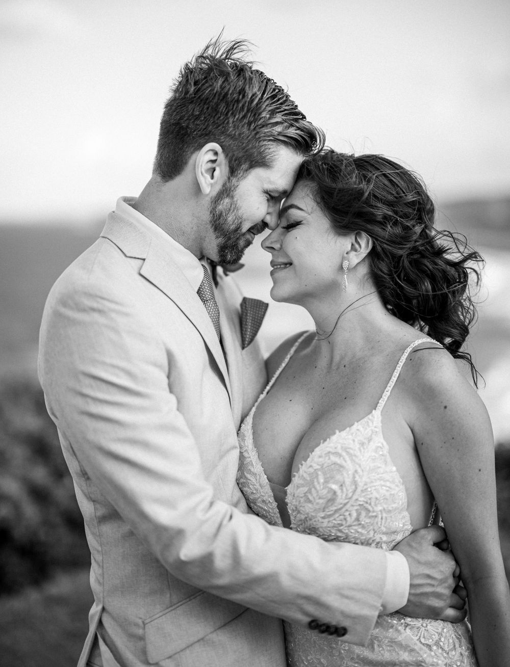 Romantic black and white portrait of newlyweds sharing an intimate moment.