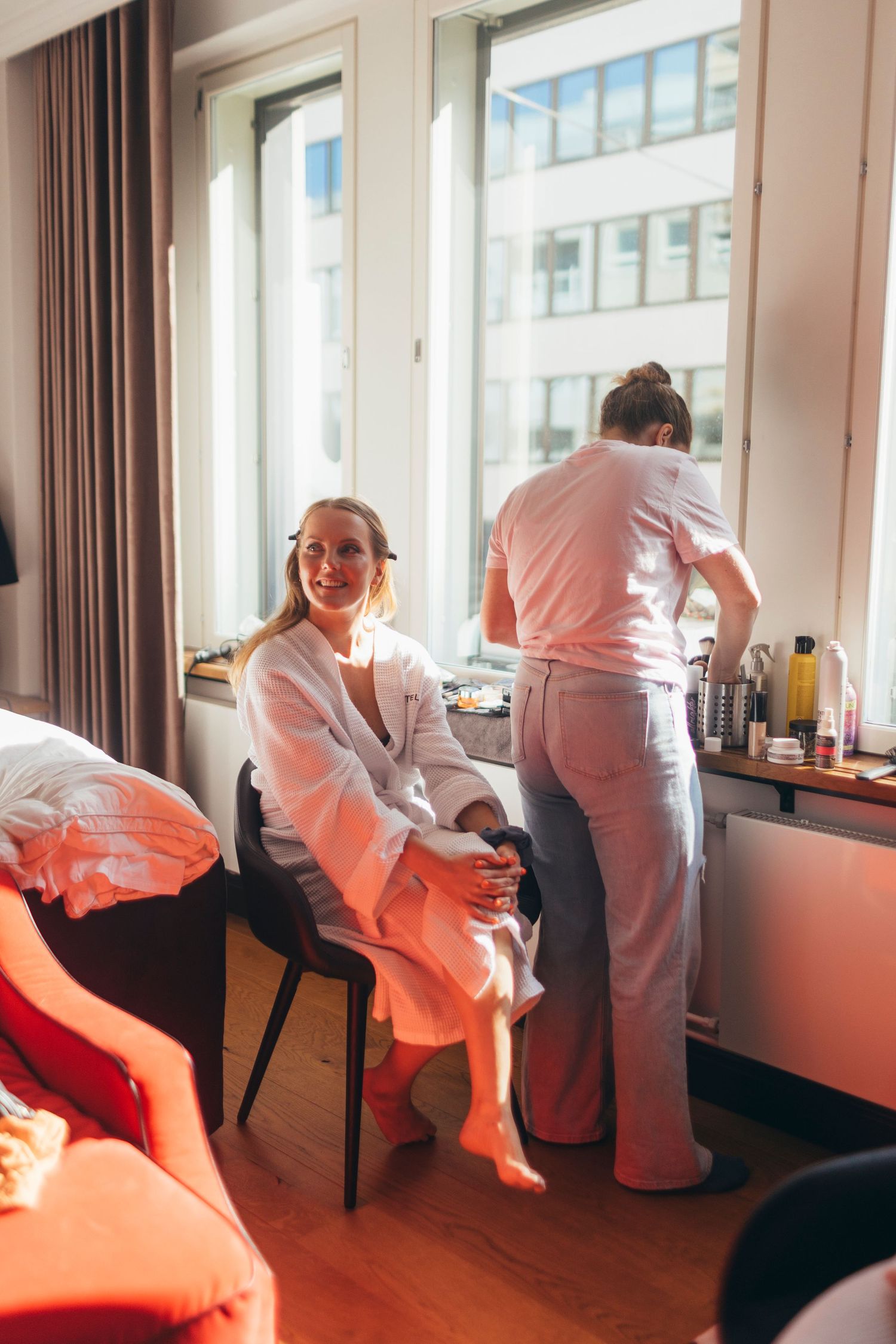 A sequence showing a bride getting ready in a sunlit hotel room.
