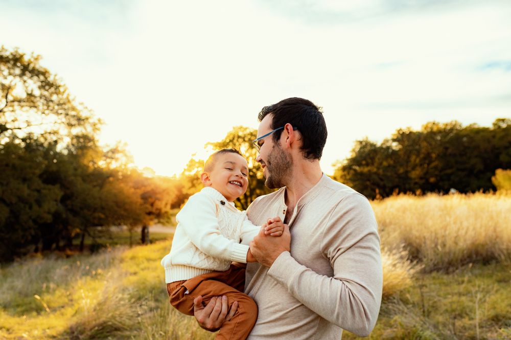 Intimate family moment captured in warm sunset light.