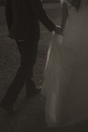 Dark and moody wedding photography showing dancing figures in formal attire.