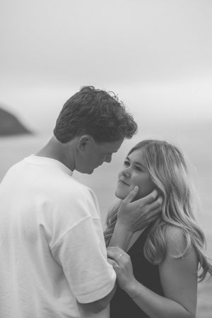 A romantic black and white sequence showing a couple embracing and kissing against a light background.