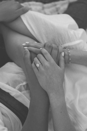 Black and white photo series showing two hands clasped together wearing wedding rings in an intimate moment.