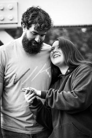 A romantic black and white photo sequence showing a couple sharing playful and intimate moments together.