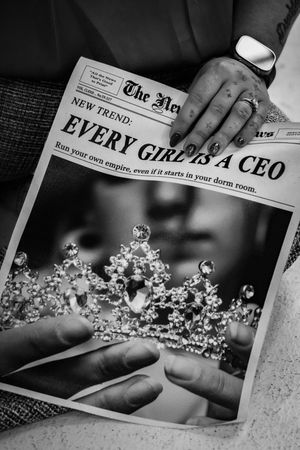 Several black and white images show someone holding delicate crystal or glass tiaras against newspaper backgrounds.