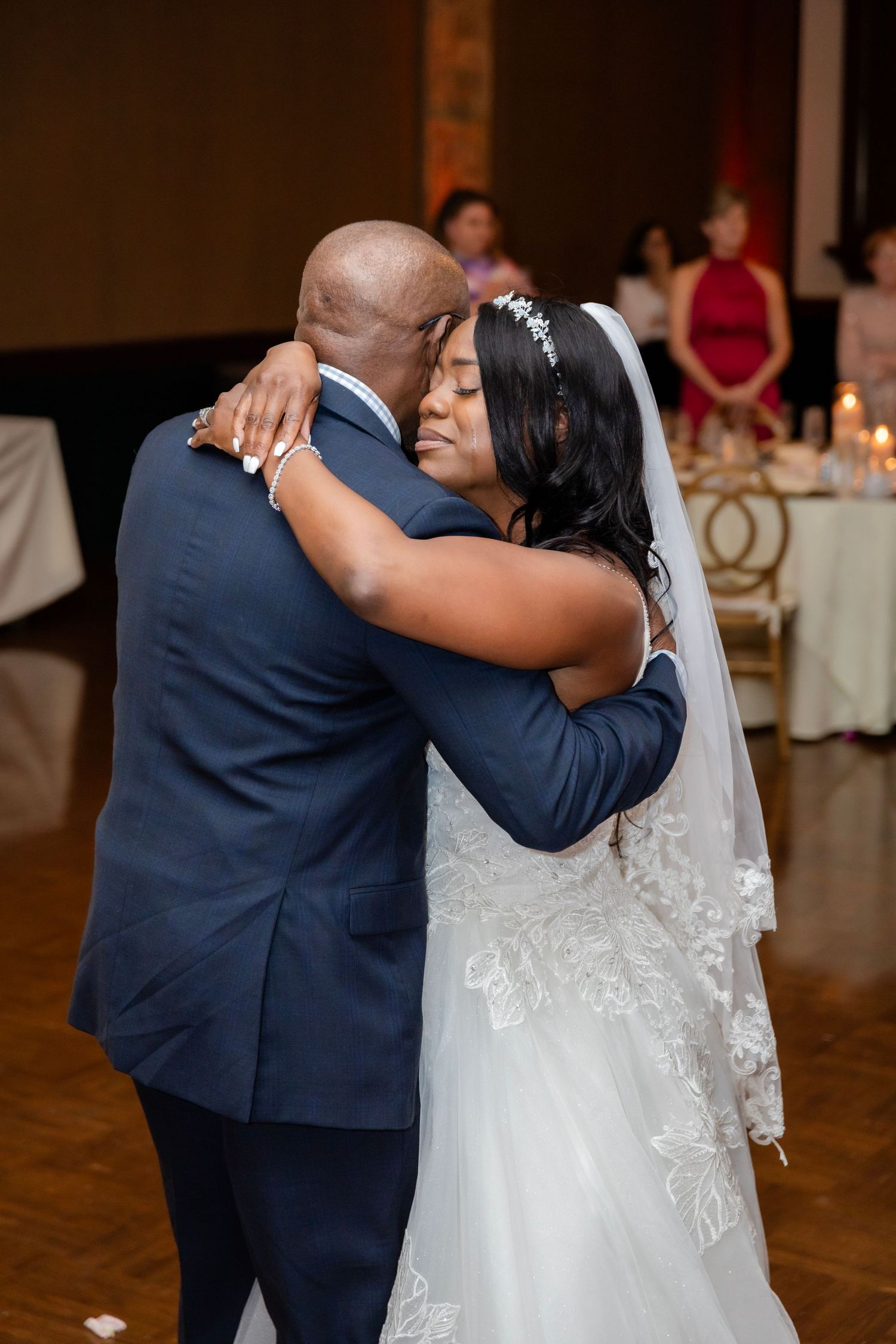 An intimate first dance moment captured at an indoor wedding reception.