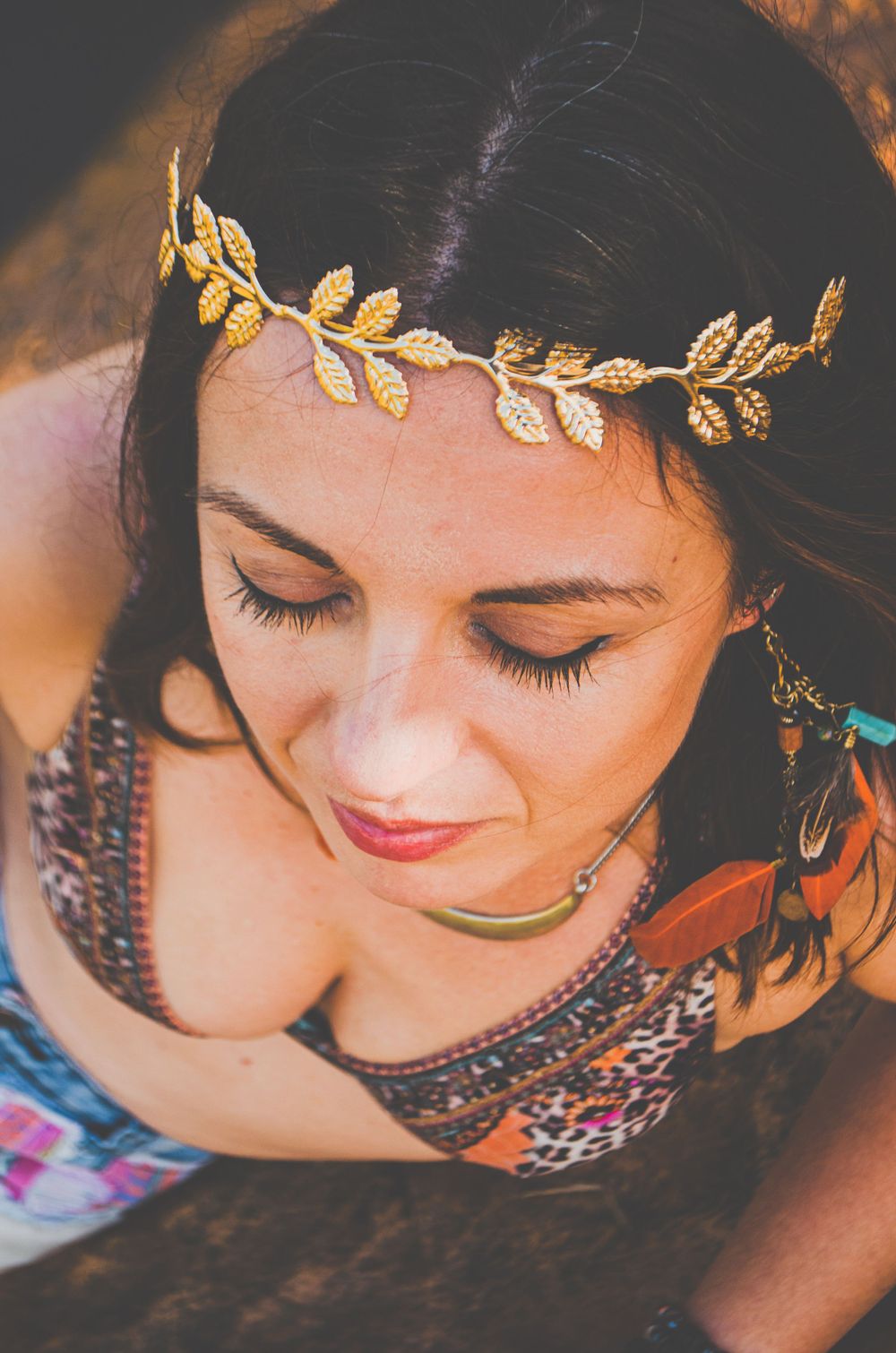 Close-up portrait featuring delicate gold leaf crown and romantic makeup.