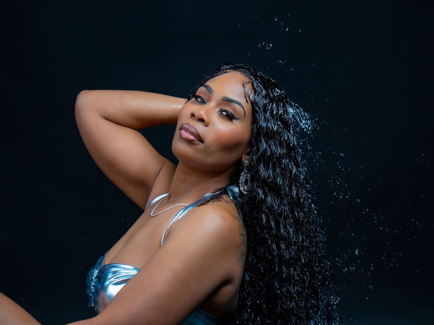 Artistic portrait series with dramatic lighting against a dark background.