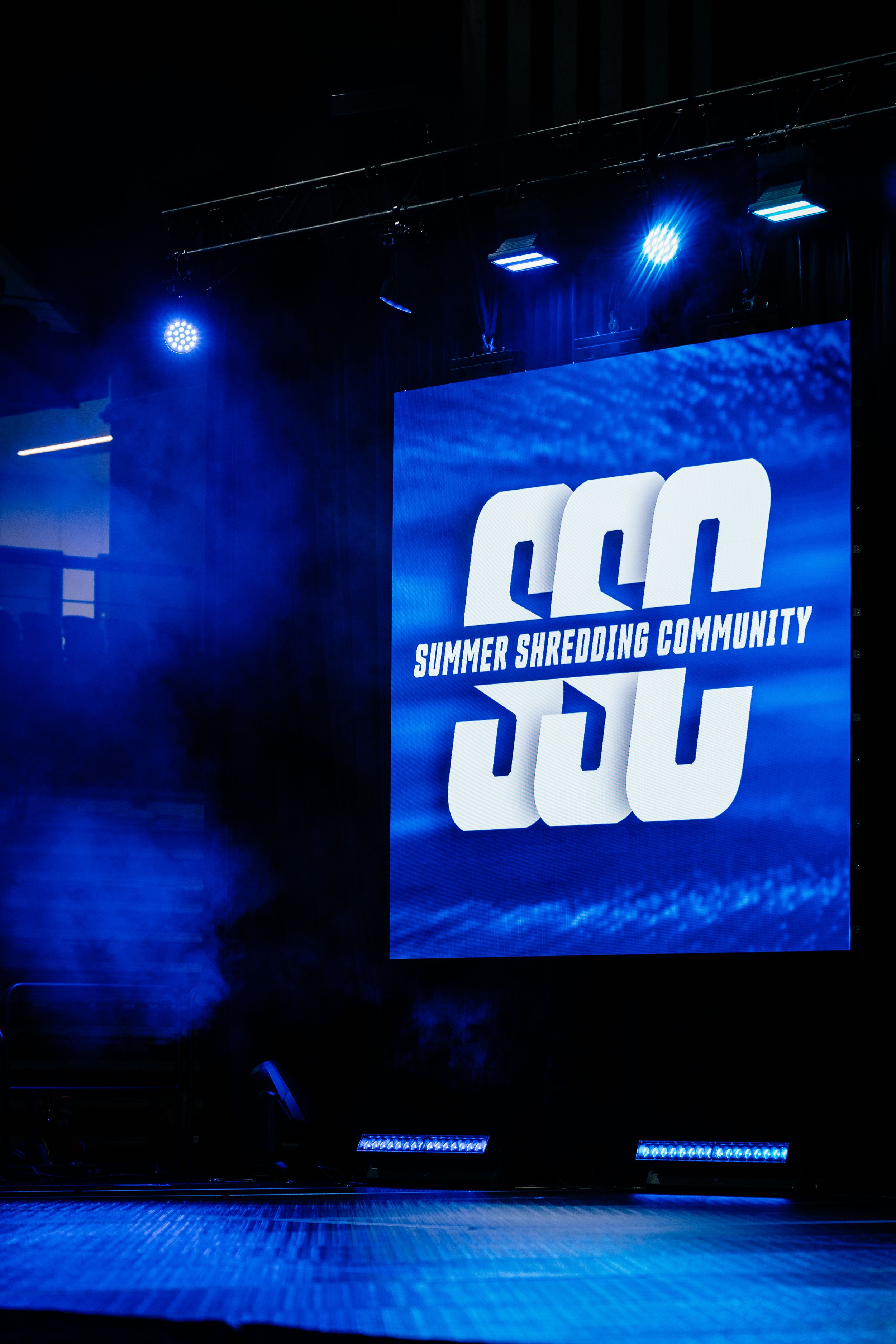 Blue-lit stage display showing 'SSC Summer Shredding Community' logo against dark background.