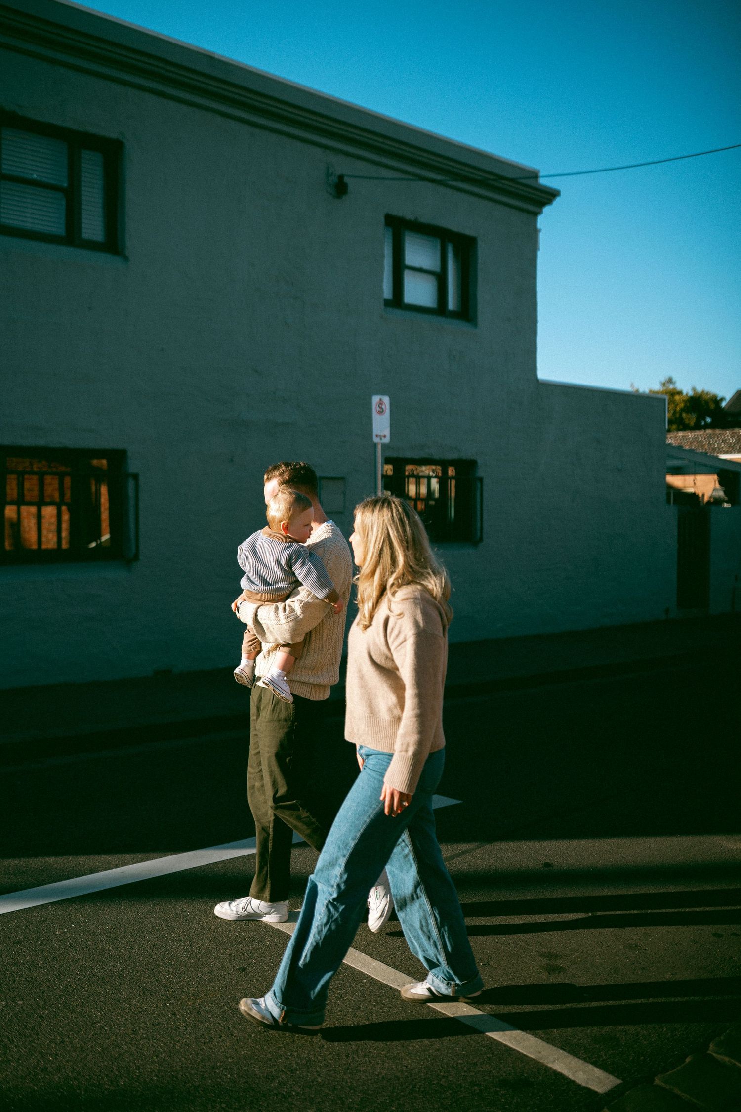 A family walks together down a suburban street during a photoshoot in Richmond.