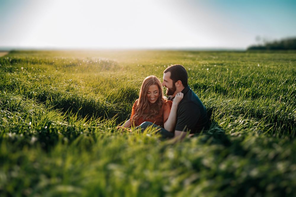 A consistent image sequence of a couple relaxing in a sunny green meadow at golden hour.