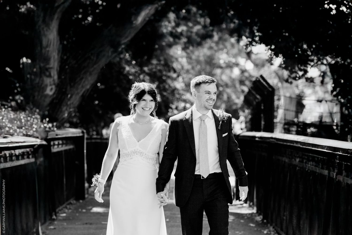 Wedding couple poses for romantic photos in front of motion-blurred red London buses on city street.