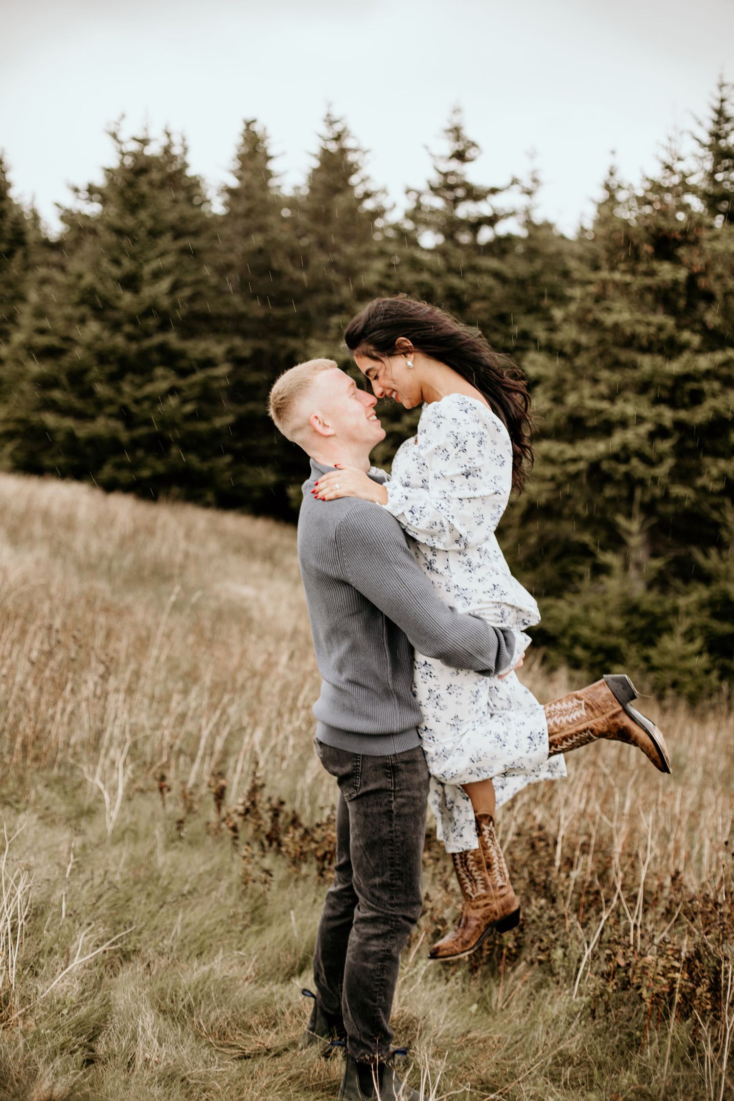 man lifting woman up in his arms with their noses touching