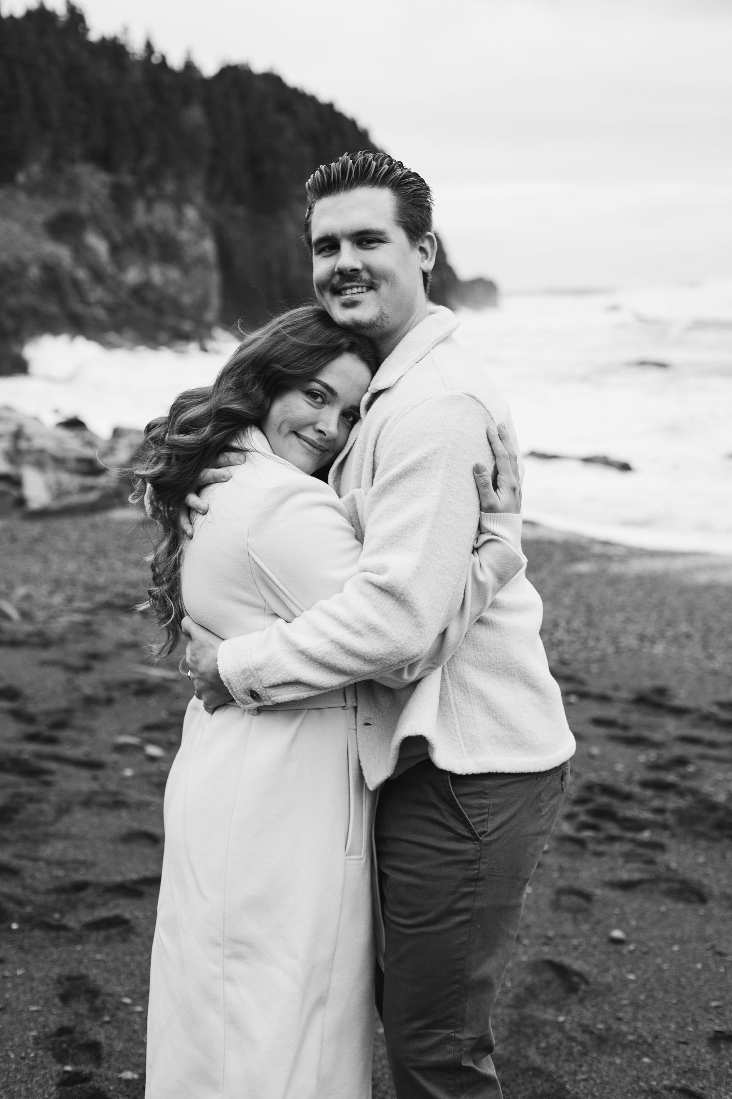 engaged couple hugging each other on the Newfoundland beach