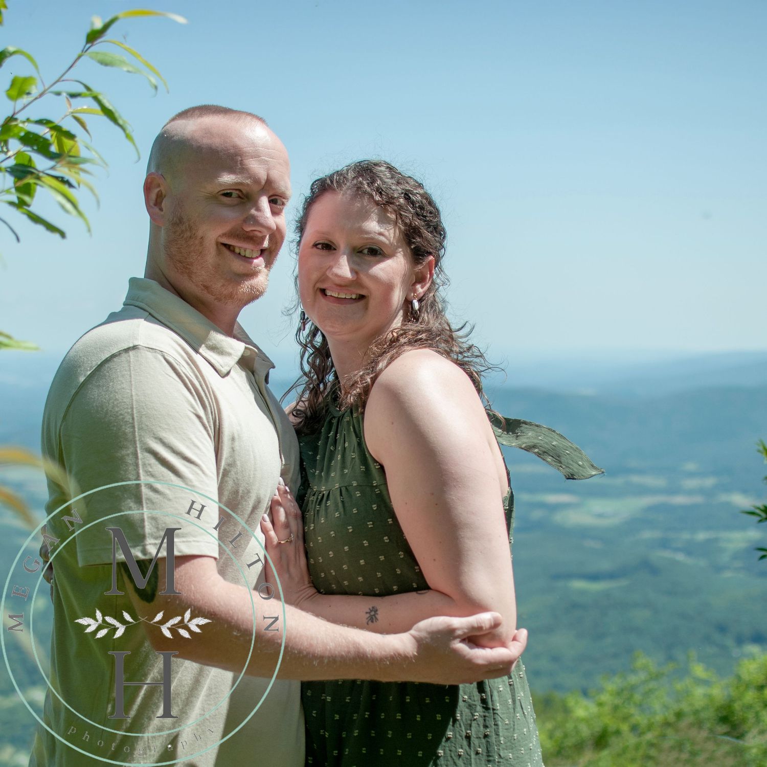 A couple poses together at an overlook at Shenandoah National Park with scenic mountain views in the background.