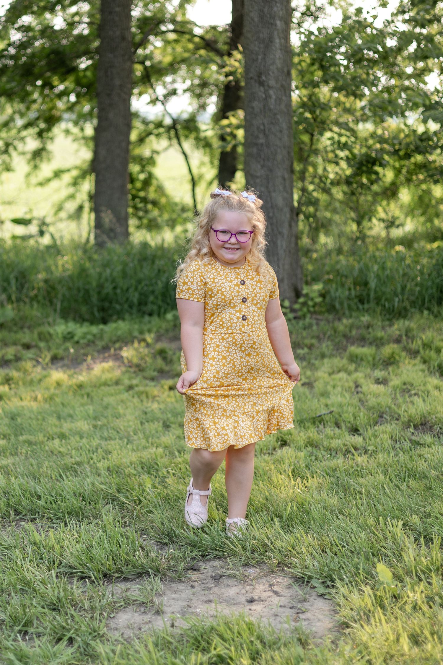 Springfield, IL Family Photographer captures a girl in a yellow dress during a portrait session in Central, IL