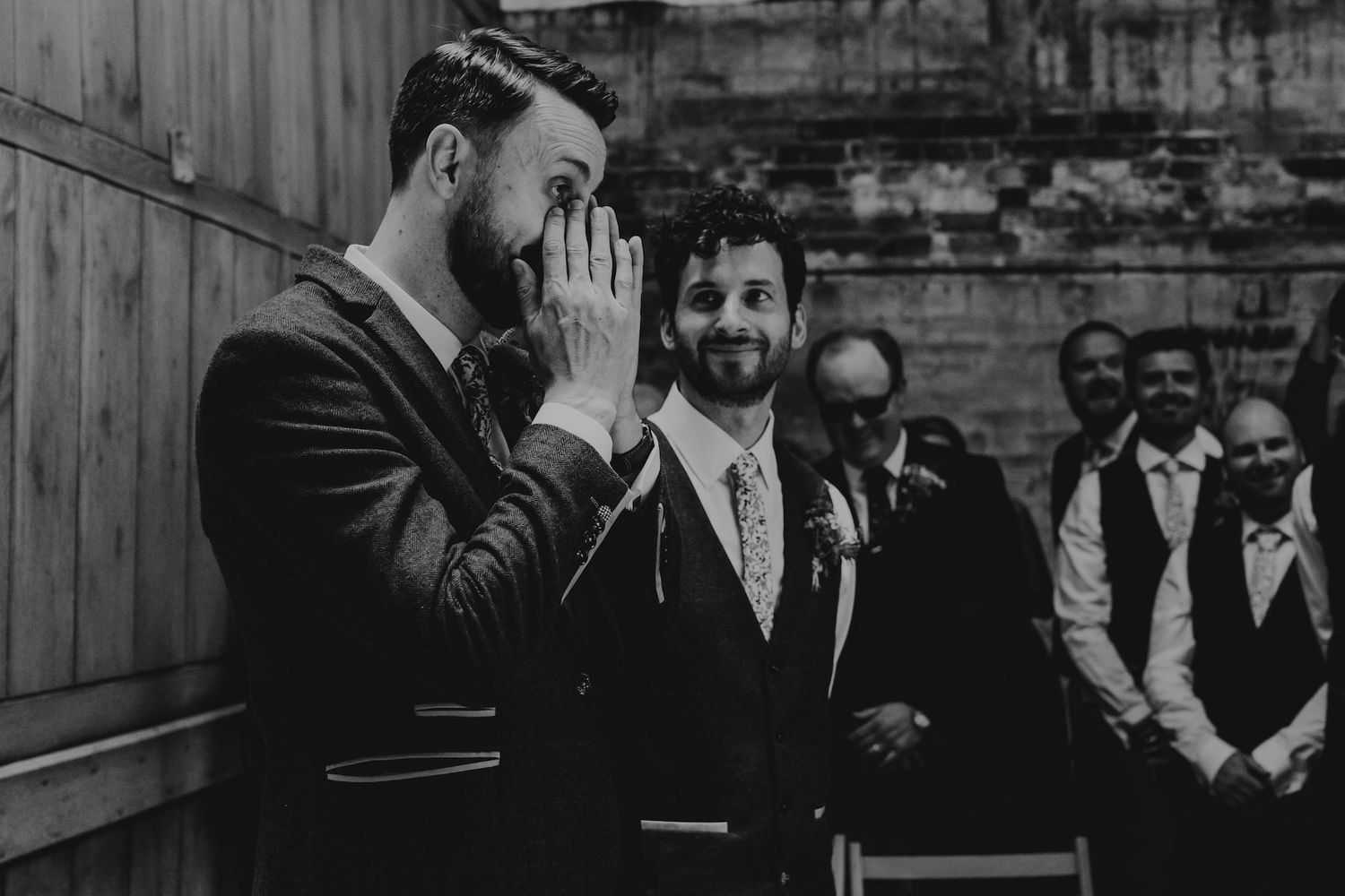 Black and white photo of an emotional moment during a wedding ceremony.