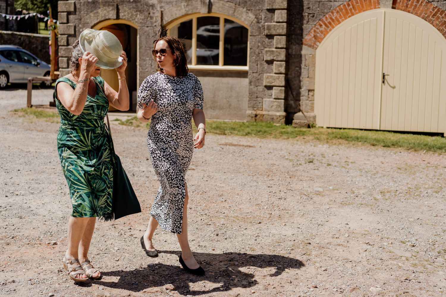 Wedding guests dancing and having fun on a rustic outdoor dance floor.