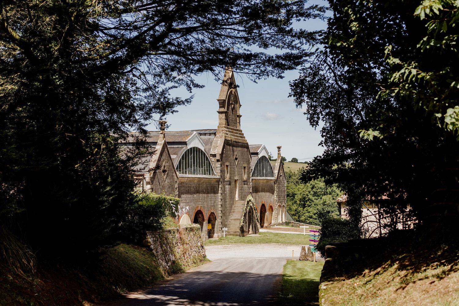 Historic stone church and buildings photographed from a distance on a sunny day.