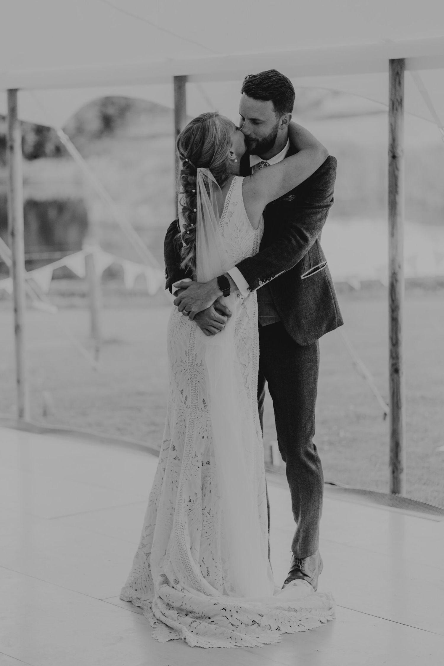 Romantic black and white wedding portraits showing tender moments between newlyweds in a garden setting.