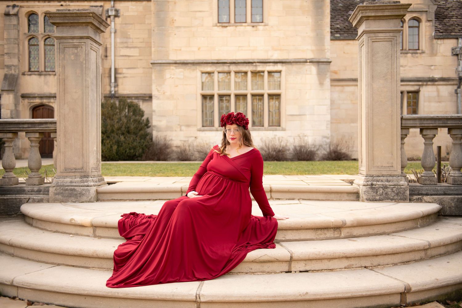 A series of outdoor photos showing someone in a flowing red dress posing elegantly against classic stone architecture.
