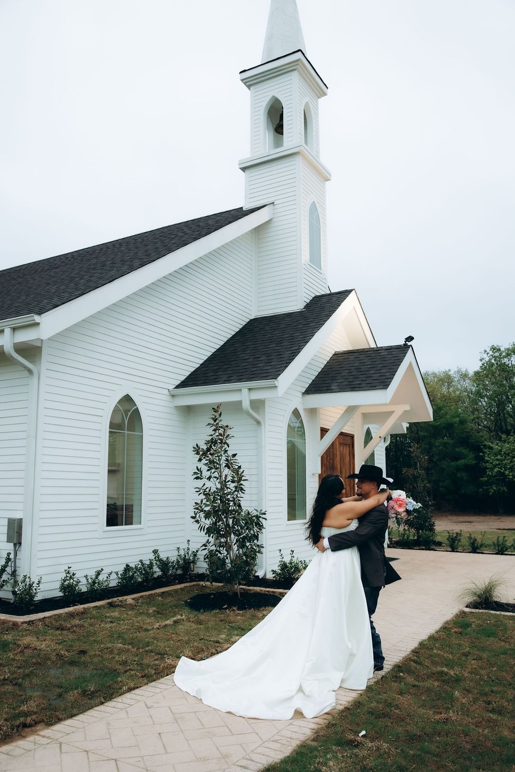 Couple in front of the chapel at The White Sparrow, a Dallas wedding venue