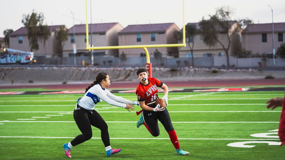 Girls flag football player running towards the camera