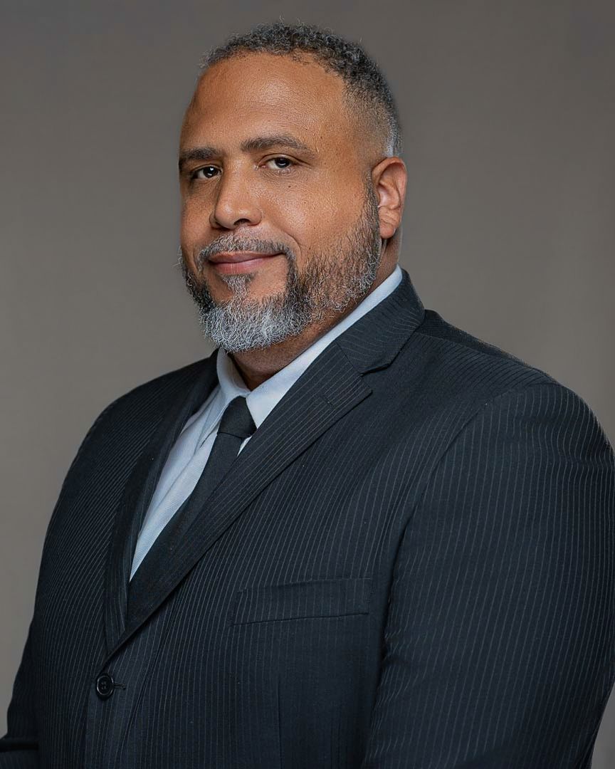 Professional portrait series showing person in pinstriped suit against neutral backdrop.