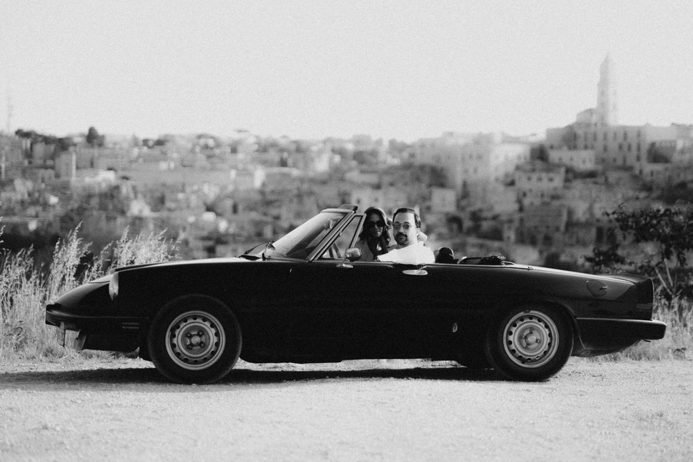 Vintage sports car appears damaged and broken down in sequence of black and white photographs.