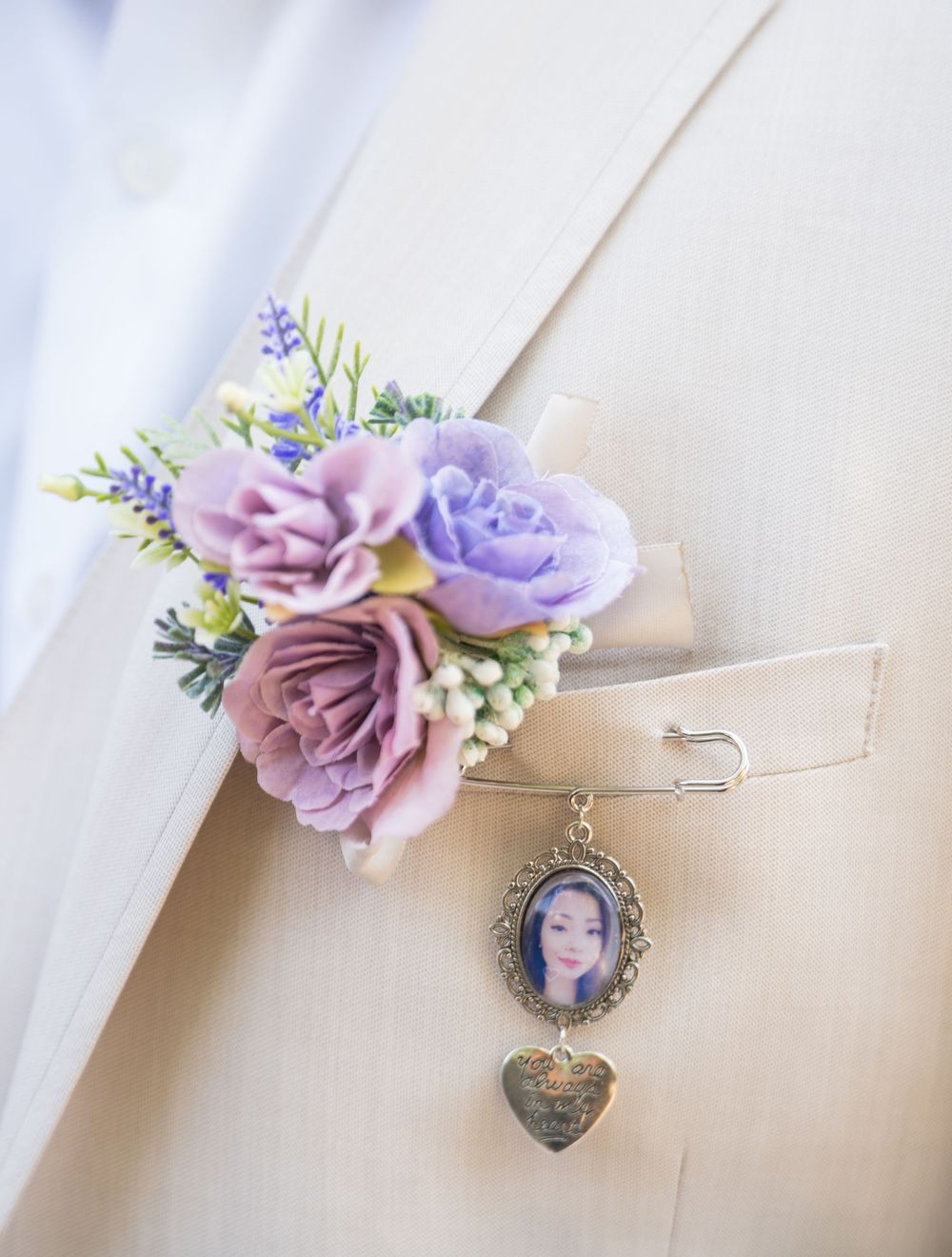 Purple and pink floral bridal bouquet charm with photo pendant attached to ribbon.