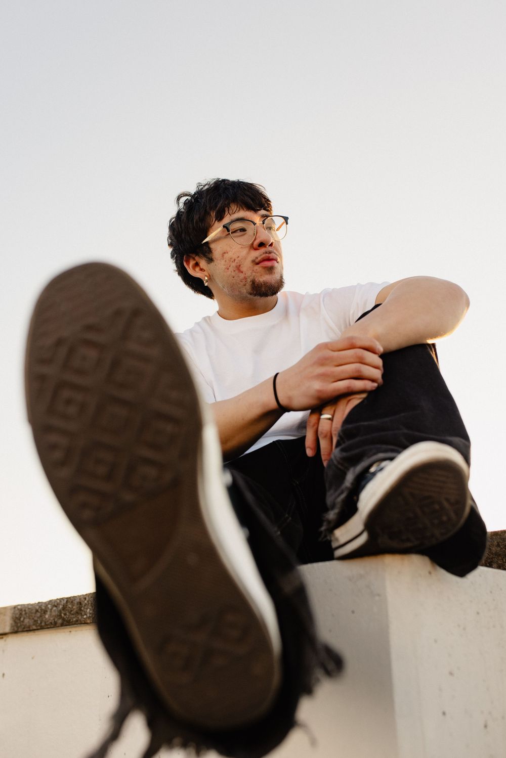 Series of dynamic shots showing person in white shirt and black pants lounging on ledge in Frederick Maryland