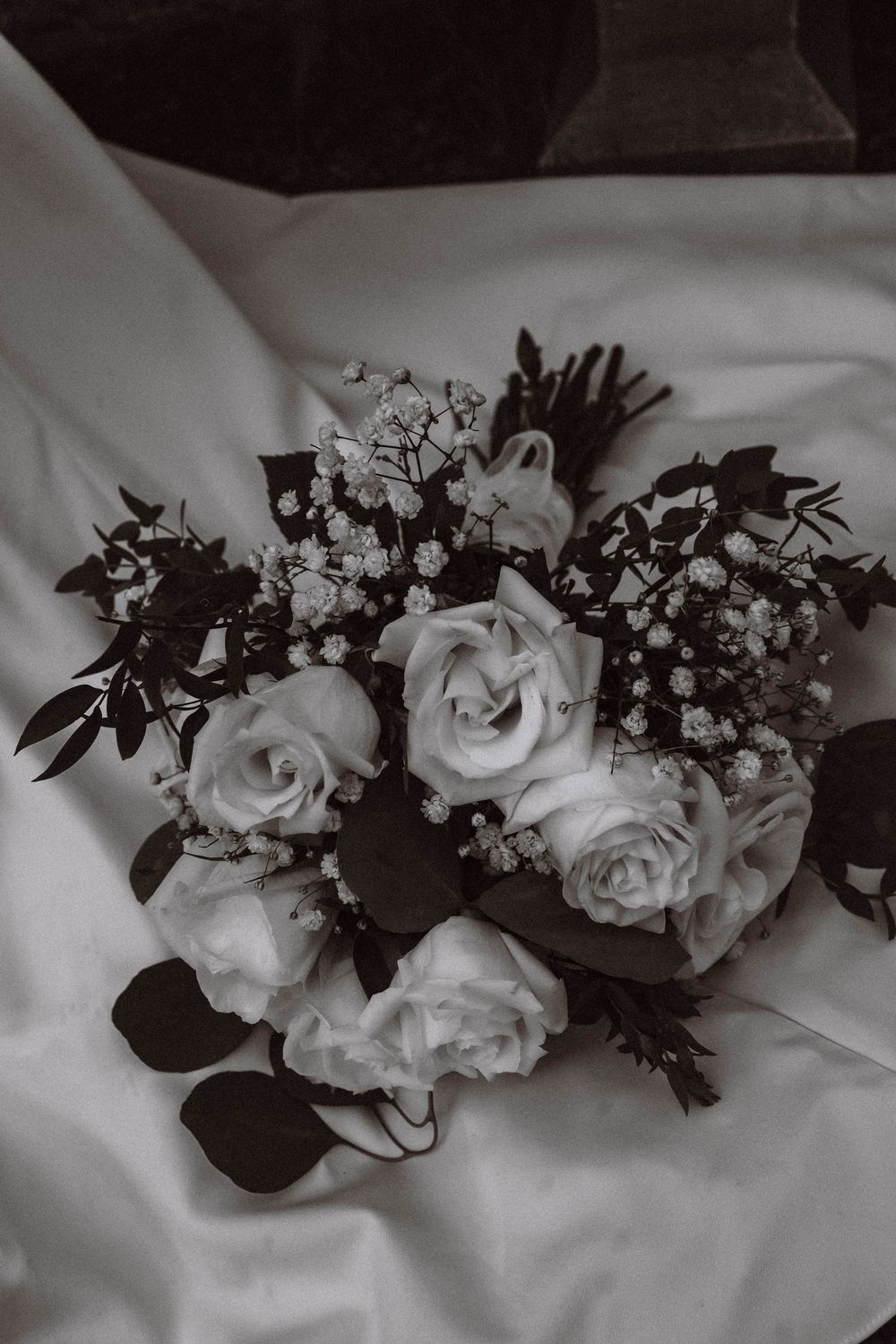 wedding bouquet detail shot on brides dress