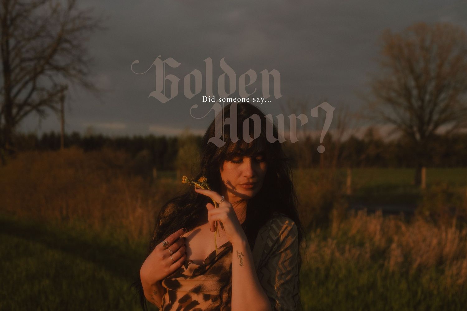 Golden hour summer portrait of a woman in a burgundy dress and embroidered jacket, standing in a lush green field near Hamilton, Ontario