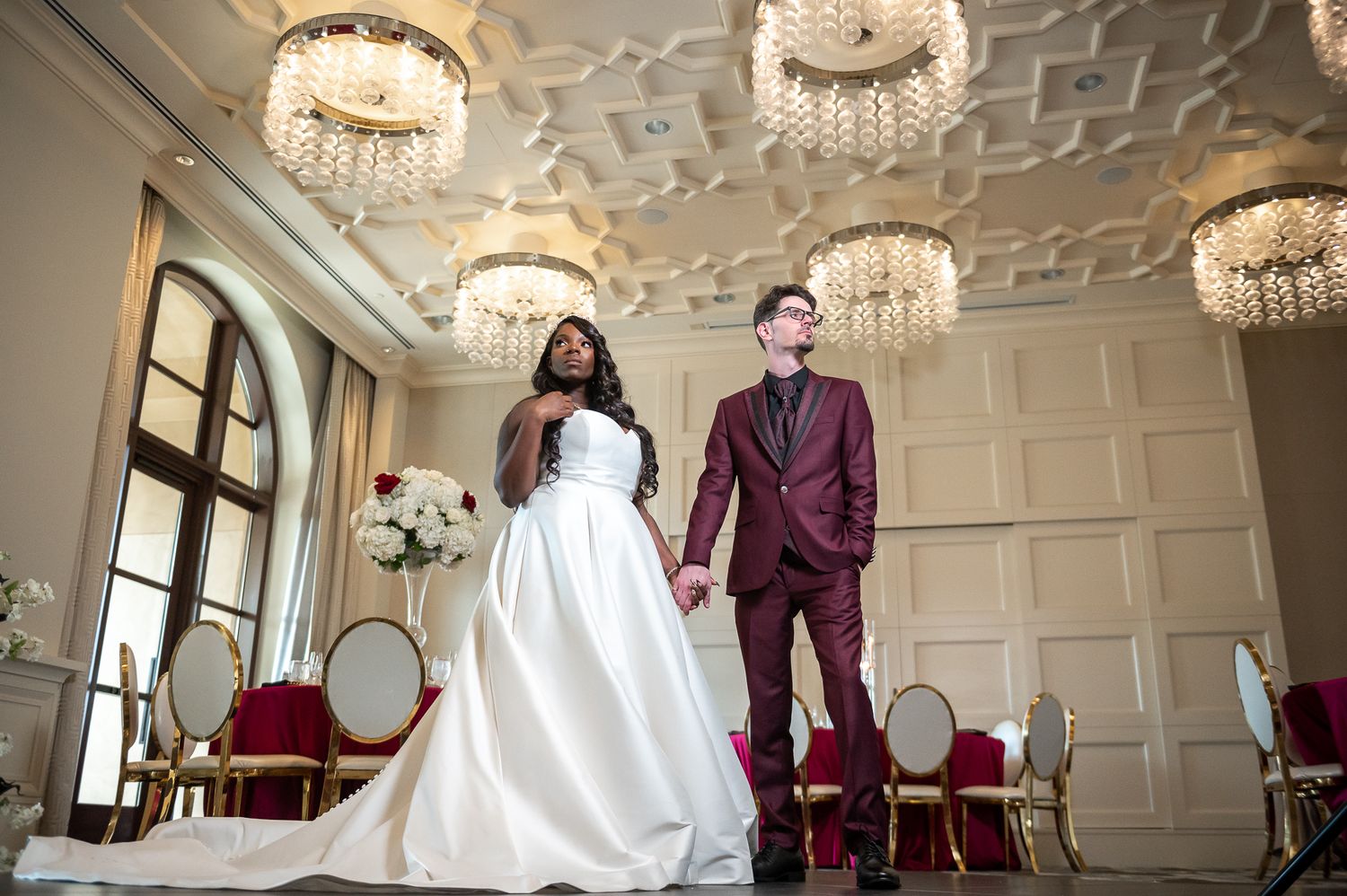 Bride and groom walking through the grand garden at a luxury Orlando wedding venue, captured in soft golden hour light.