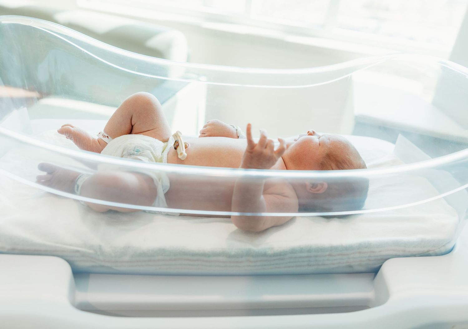 Newborn baby lying in a hospital bassinet shortly after birth in a medical setting.
Fresh 48 hospital session
 simple timeless natural