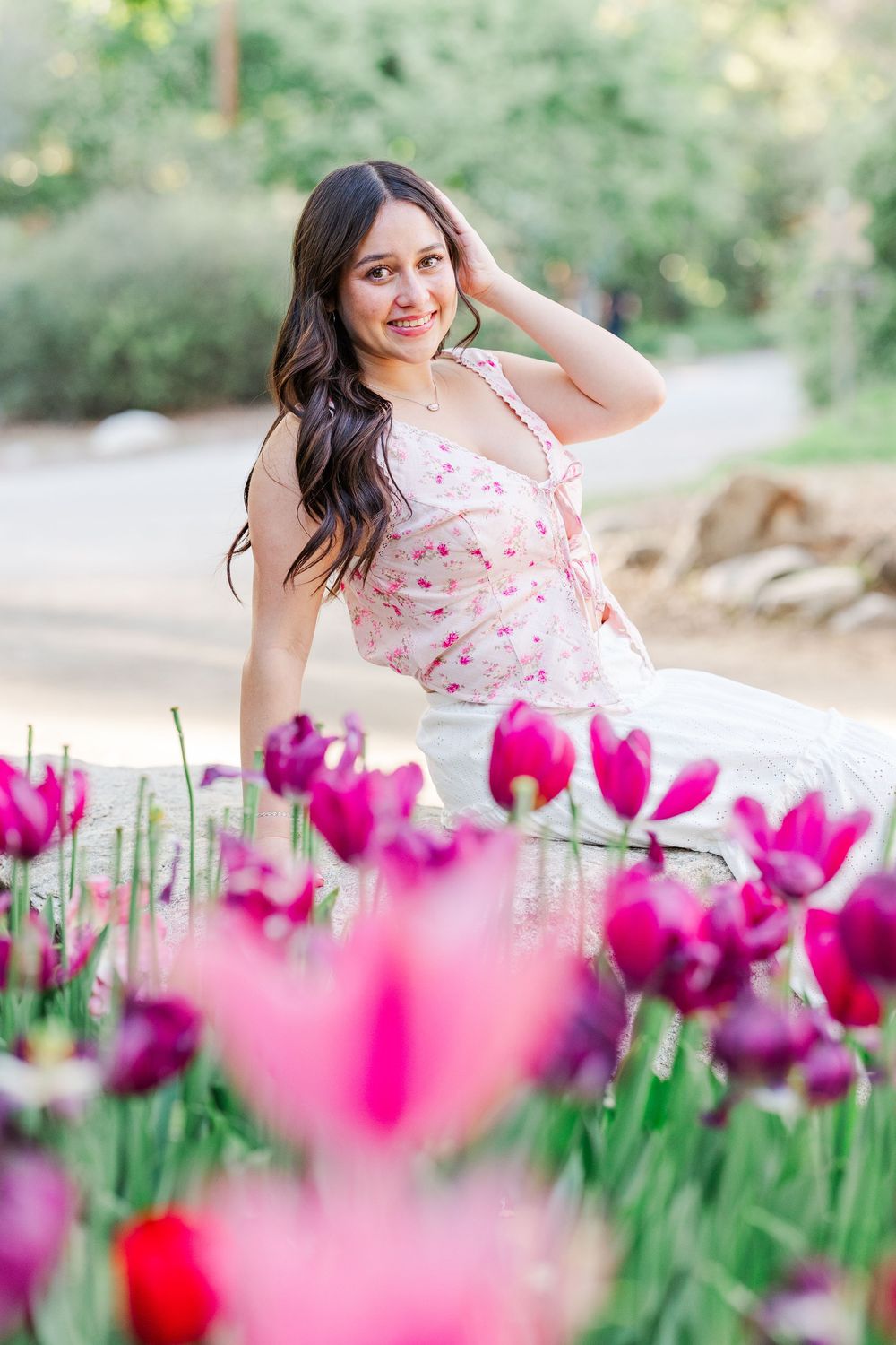 Beautiful floral portrait with bright pink tulips in foreground and soft natural lighting in outdoor garden setting.