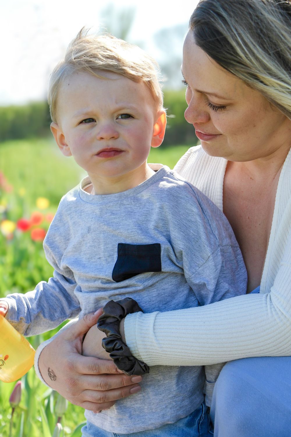 Tender moment captured between two people in a spring garden with tulips.