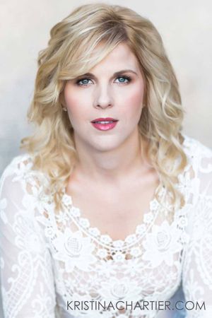 Professional beauty portrait with soft curls and white lace dress.