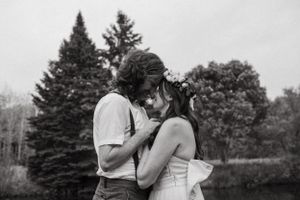 Black and white romantic portrait of couple sharing intimate moment outdoors.