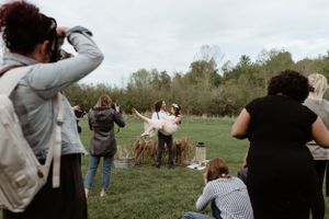 Photographers capturing a special moment in an outdoor field setting.