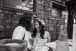 A black and white capture of an intimate dining moment with candlelight and rustic details.