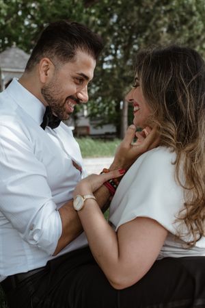 Close-up of a couple sharing an intimate moment outdoors.