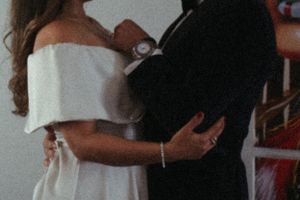 Close up of couple embracing in formal attire.
