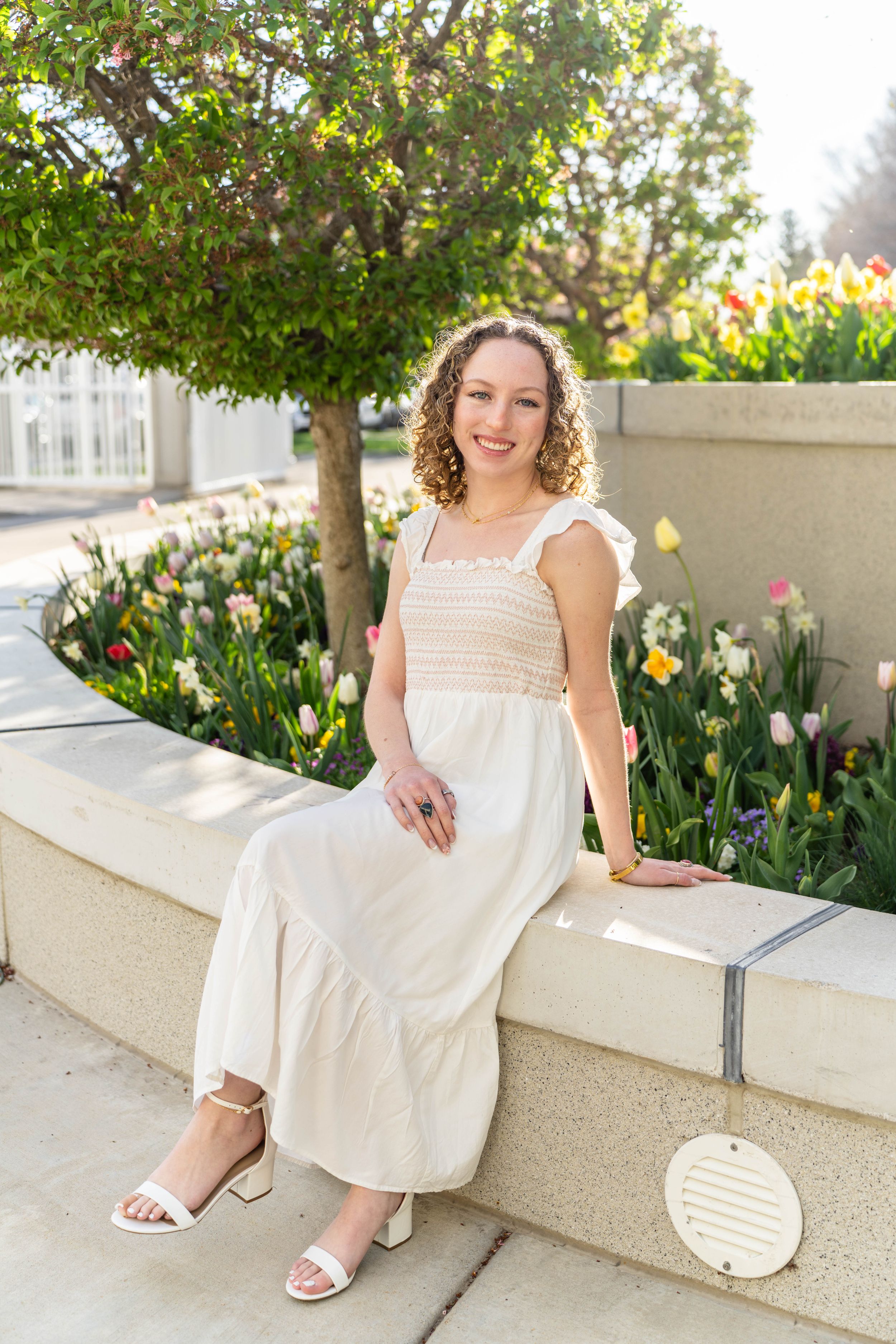 A girl posing in white sundress at mount timpanogos temple in American Fork, Utah.
