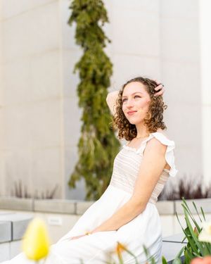 A girl posing in white sundress at mount timpanogos temple in American Fork, Utah.