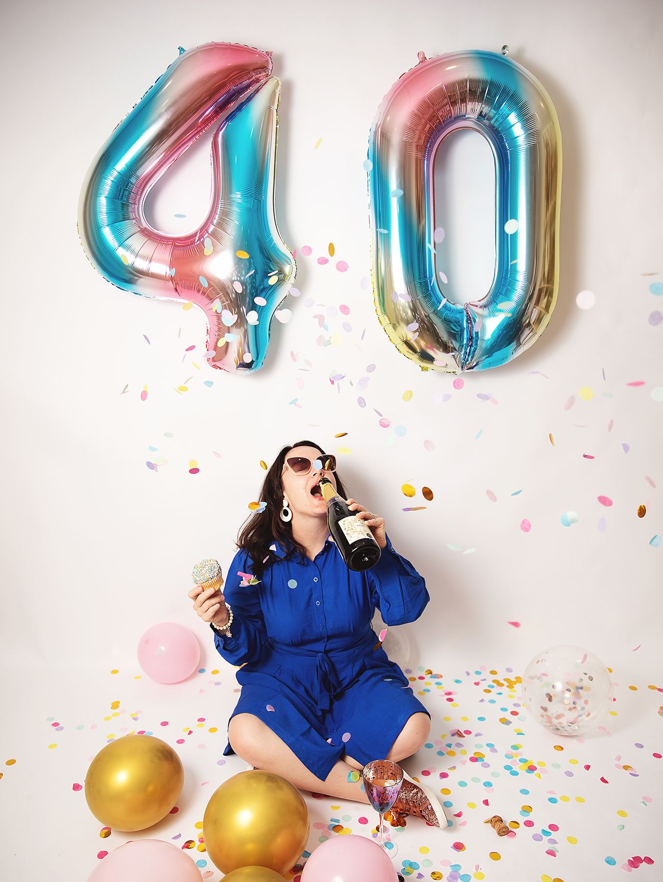 Festive 40th birthday celebration scene with holographic number balloons, confetti, and golden orbs against white background in Sidcup