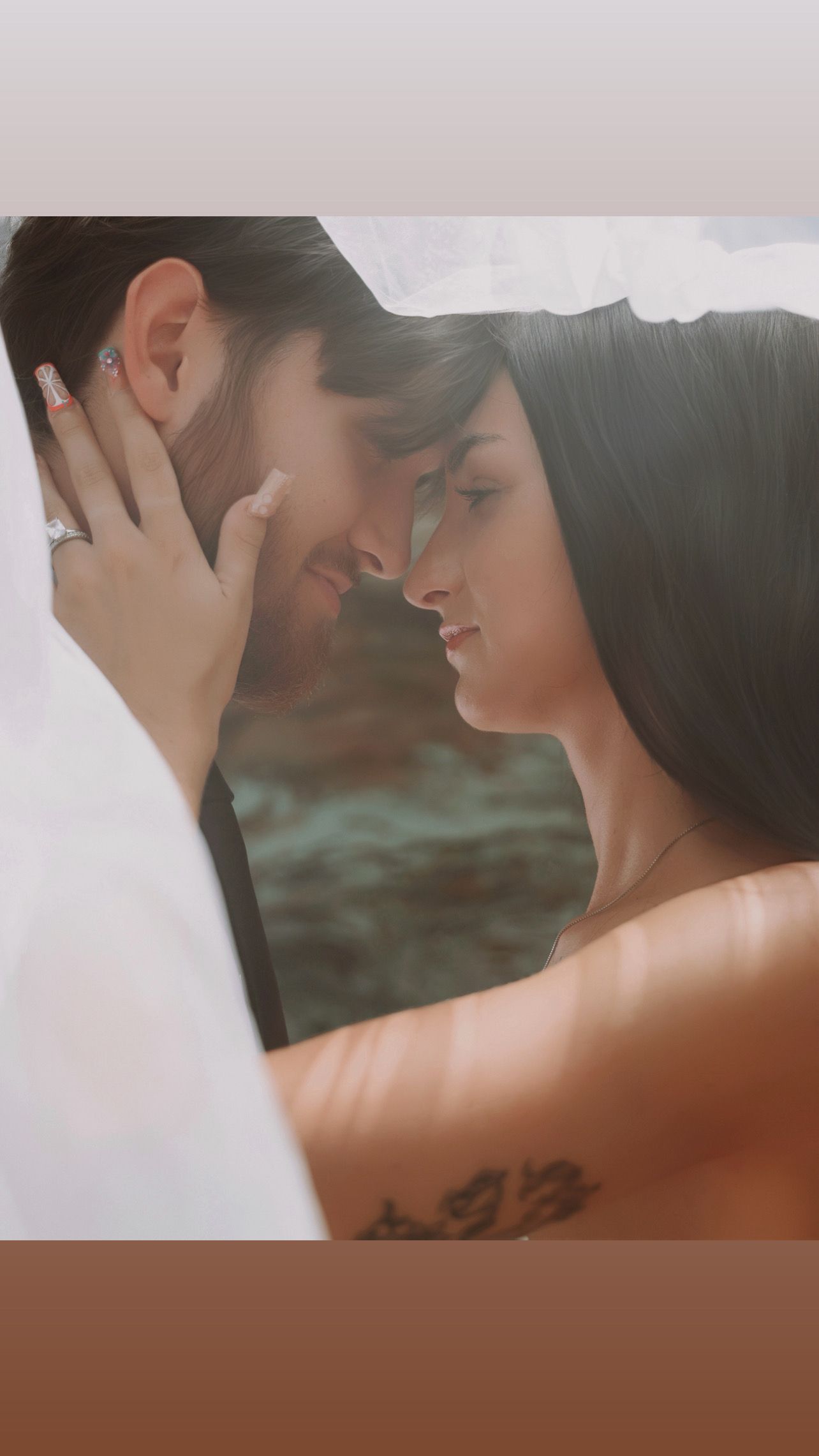 Bride in white gown holds elegant bouquet of white roses with diamond engagement ring visible.
