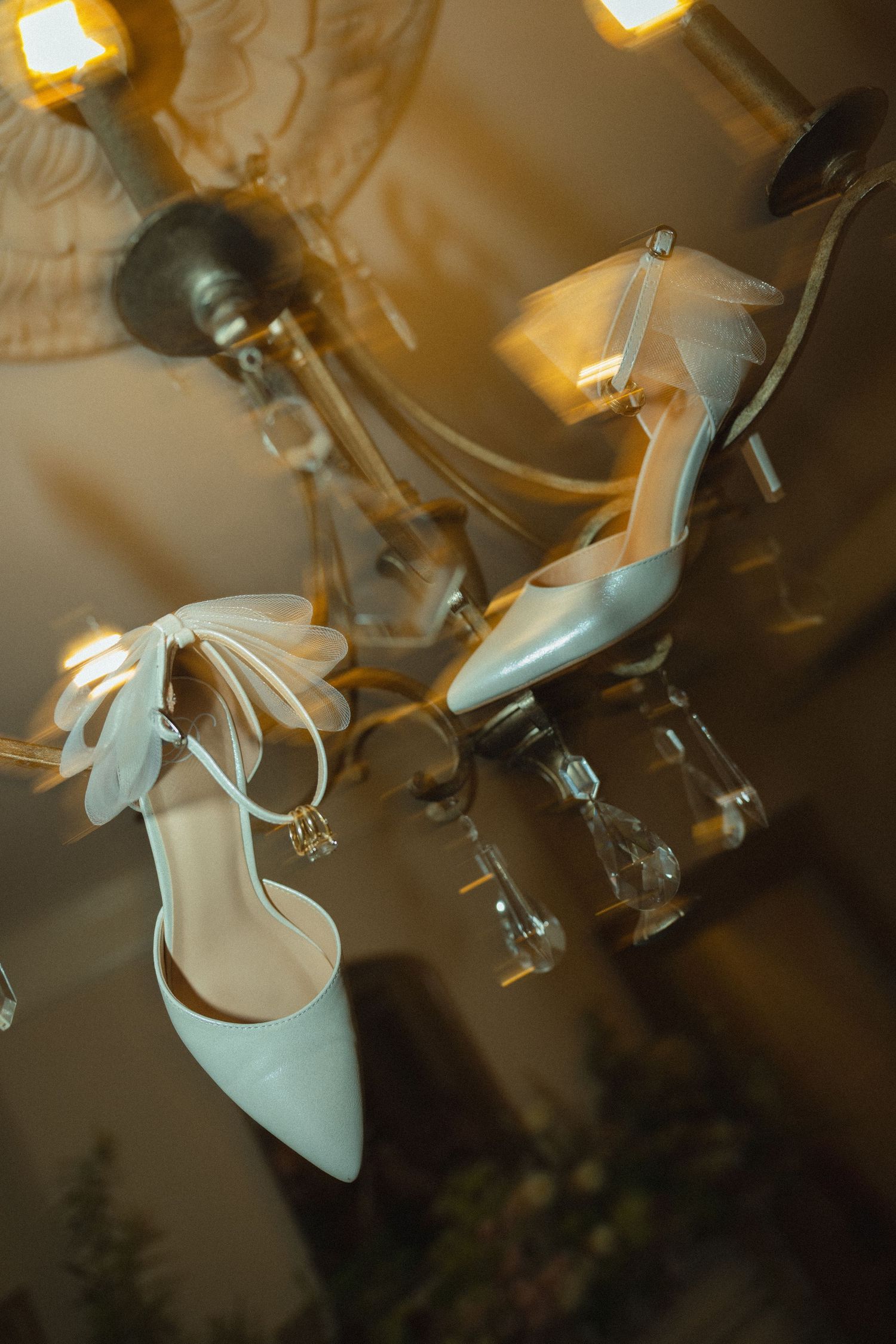 Bride and groom's shoes hanging off of chandelier at The Bentley House in St. George, Utah