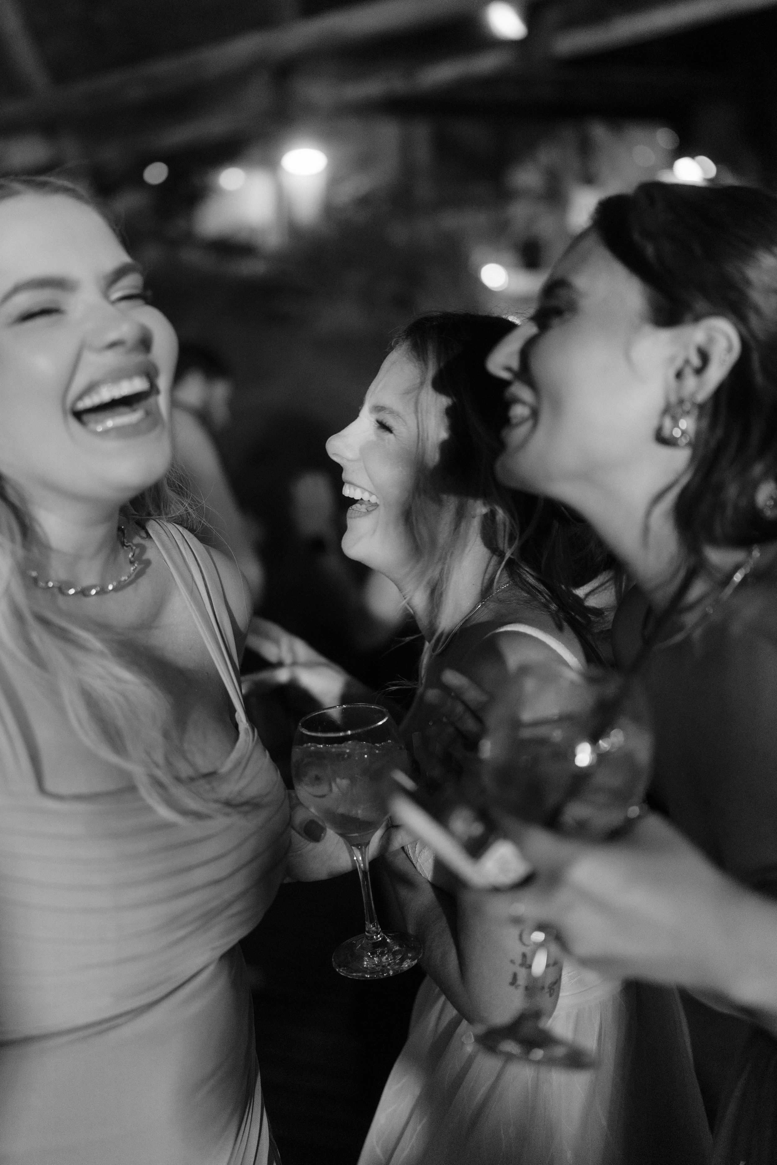 Friends laughing and enjoying themselves at a nighttime party.
